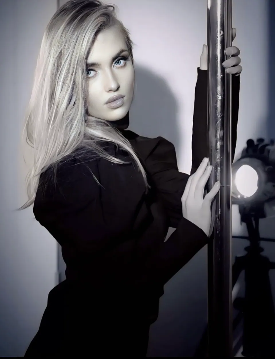 Paula Maria Rosalia in black editorial styling beside studio lighting