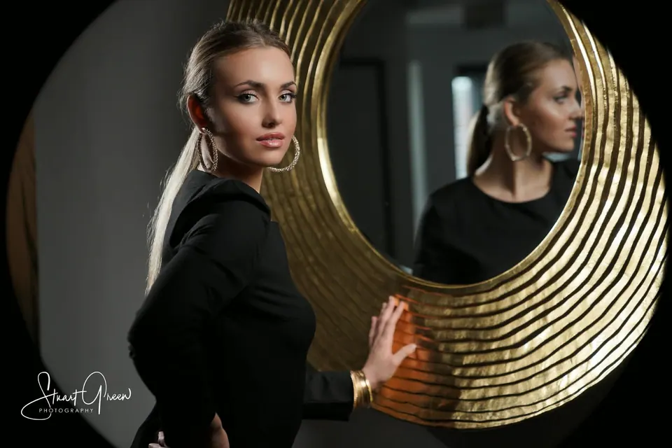 Paula Maria Rosalia posed beside a gold circular mirror