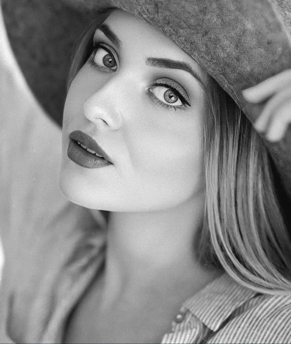 Paula Maria Rosalia in a close black and white hat beauty portrait
