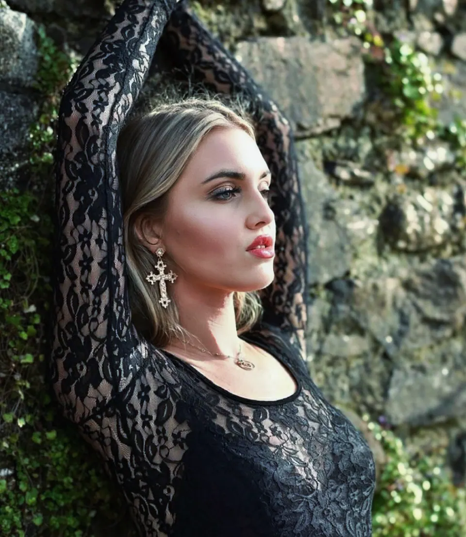 Paula Maria Rosalia in black styling against a tree for an editorial profile