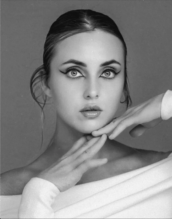Paula Maria Rosalia in a black and white beauty portrait with hands framing the face
